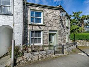 A stone building with two windows and a door, a satellite dish, and a small fence. - 1 Bed in Kendal (oc-94210) (Kendal)
