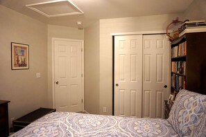 A bedroom with a bed, a bookshelf, and two doors. - Perfect Vacation Haven for the Active and Musical Family (Superior)