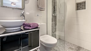 A bathroom with a sink, mirror, towel rack, and shower. - 1 Bed in Redruth (oc-90897) (Redruth)