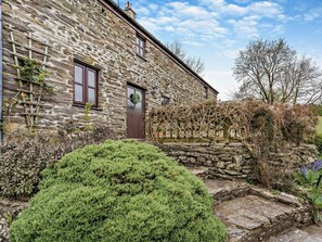 A stone building with a door, windows, and a small garden area. - 3 Bed in Llandysul (oc-94117) (Rhydlewis)