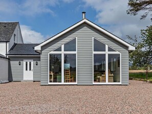 A modern house with a grey exterior, large windows, and a chimney. - 7 Bed in Spean Bridge (oc-88687) (Highbridge)