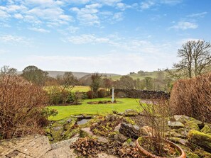 A rural landscape with a stone wall, a grassy field, and a clear sky. - 3 Bed in Wigton (oc-93461) (Hesket Newmarket)