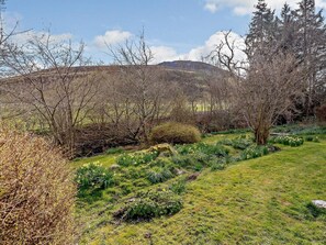 A natural landscape with a grassy area, trees, and a hill in the background. - 2 Bed in Biggar (oc-ca366) (Biggar)