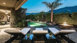 A pool area with lounge chairs, a dining area, and a view of mountains. - 5 BR Custom Mediterranean Estate In Andreas Hills, 5 King Beds Putting Green... (Palm Springs)