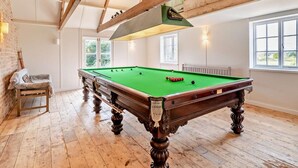 A pool table in a room with wooden beams, a window, and a bench. - 1 Bed in Sherborne (oc-94306) (Chetnole)