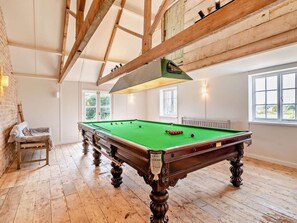 A pool table in a room with wooden beams, a window, and a bench. - 1 Bed in Sherborne (oc-94306) (Chetnole)