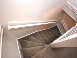 A staircase with carpeted steps and white walls. - 2 Bed in Keswick (oc-94352) (Keswick)