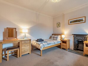 A bedroom with a bed, desk, chair, and a fireplace. - 2 Bed in Keswick (oc-94352) (Keswick)