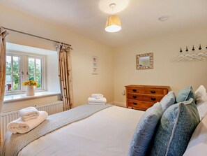 A bedroom with a bed, a dresser, a radiator, a window with curtains, a hanging light fixture, and a wall-mounted mirror. - 5 Bed in Gosforth (oc-sz344) (Irton with Santon)
