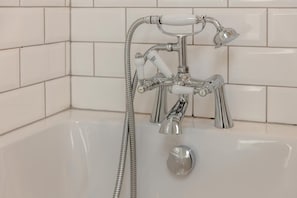 A modern bathroom with a chrome faucet, a handheld showerhead, and a separate hot water outlet. - 4 Bed in Torrington (oc-78199) (Langtree)