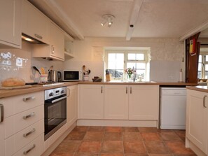 A kitchen with white cabinets, a stove, oven, microwave, and dishwasher. - 4 Bed in Honiton (oc-41045) (Sheldon)