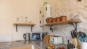 A kitchen with a microwave, toaster, and various utensils on the counter. - 1 Bed in Bideford (oc-pwork) (Buckland Brewer)