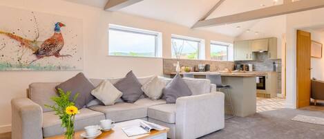A modern living room with a sofa, coffee table, and artwork.