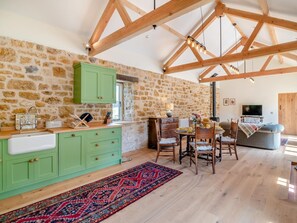 A rustic kitchen with stone walls, wooden beams, and a green countertop. - 2 Bed in Stoke Abbott (oc-94406) (Stoke Abbott)