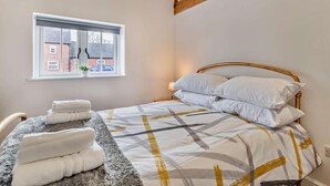 A bedroom with a bed, a window, and a chair. - 3 Bed in Ashbourne (oc-94309) (Waldley)