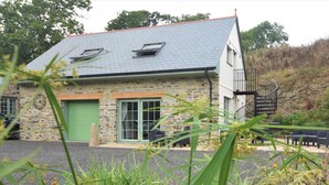 A stone building with a grey roof, a green door, and a spiral staircase. - 1 Bed in Launceston (oc-86675) (South Petherwin)