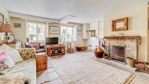 A cozy living room with a fireplace, a television, and a comfortable seating area.