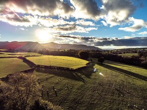 A rural landscape with fields, a fence, and distant hills under a partly cloudy sky. - 2 Bed in Cradoc (BN103) (Cradoc)