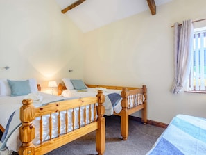 A bedroom with two wooden beds, a window with curtains, and a lamp on the nightstand. - 2 Bed in Cradoc (BN103) (Cradoc)