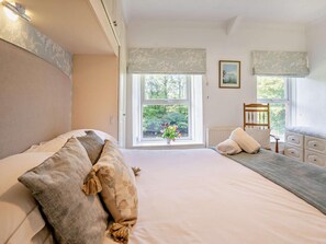 A bedroom with a bed, a chair, a dresser, and a window with a view of greenery. - 4 Bed in Ystradgynlais (oc-bn273) (Ystradgynlais)