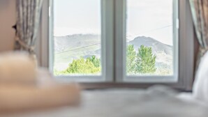 A room with a large window offering a view of a mountainous landscape. - 4 Bed in Cockermouth (oc-91210) (Wythop)