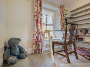 A room with a large window, a chair, a teddy bear, and a bookshelf. - 2 Bed in Eden Valley (SZ455) (Warcop)