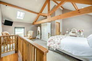 A bedroom with a bed, a chair, a dresser, a mirror, and a television mounted on the wall. - 1 Bed in Cleator (oc-92310) (Ennerdale and Kinniside)