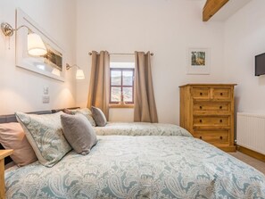 A bedroom with a bed, a wooden dresser, a window with curtains, and a wall-mounted lamp. - 2 Bed in Newlands Valley (SZ352) (Borrowdale)