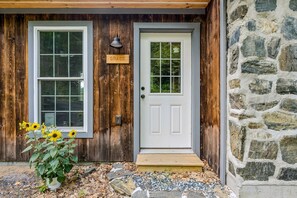 A wooden house with a white door, a window, and a sign that reads 'GRACE.' - Grace Cottage - Serene Private Location (Strafford)