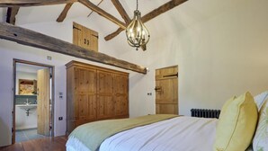 A bedroom with a wooden ceiling, a bed with white bedding, a hanging light fixture, and wooden cabinets. - 3 Bed in Windermere (oc-sz596) (Windermere)