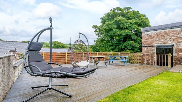 A patio with a black chair, a hanging chair, and a picnic table. - 6 Bed in St Bees (SZ558) (Rottington)