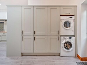 Ein Waschraum mit einem großen Schrank und zwei Waschmaschinen.