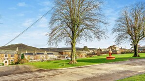 A rural setting with a stone building labeled 'The Stag Inn,' a grassy area, and a hill in the background. - 2 Bed in Appleby-in-westmorland (oc-91029) (Dufton)