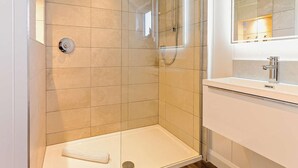 A modern bathroom with a glass-enclosed shower, a white sink, and a mirror above the sink. - 2 Bed in St. Andrews (oc-93230) (St Andrews)