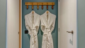 A door with two white robes hanging on a wooden rack. - 2 Bed in Arbroath (oc-84649) (Carmyllie)