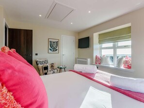 A hotel room with a bed, a chair, a small table, a TV, a window with a view, and a door. - 2 Bed in Arbroath (oc-84649) (Carmyllie)