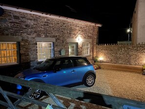 A stone building with a car parked in front.