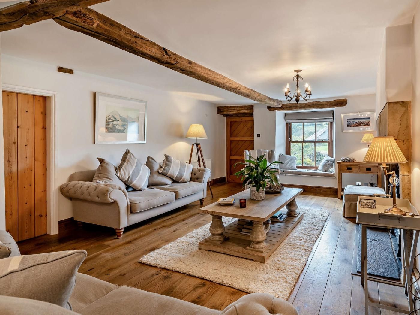 A cozy living room with a sofa, a coffee table, and a lamp.
