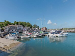 A marina with boats docked, a pier, and buildings in the background. - 2 Bed in Padstow (oc-88178) (Padstow)