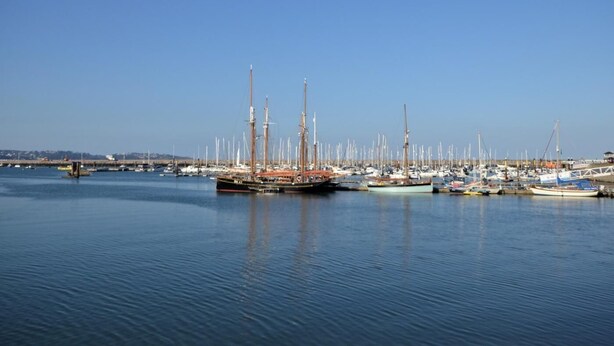 A marina with multiple boats docked, calm water, and a clear sky. - 2 Bed in Brixham (oc-bx087) (Brixham)