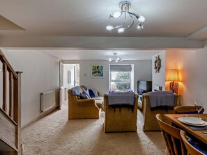 A living room with a sofa, armchairs, a dining table, and a TV. - 3 Bed in Portland (oc-94623) (Portland)