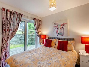 A bedroom with a bed, curtains, a painting, and a nightstand. - 1 Bed in Ambleside (oc-94656) (Grasmere)