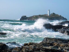 A rocky coastline with a lighthouse on a small island. - 1 Bed in Redruth (oc-93858) (Redruth)