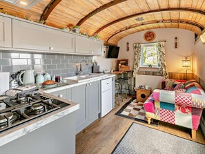 A compact kitchen with a gas stove, a sink, and a small refrigerator. - 1 Bed in Redruth (oc-93858) (Redruth)