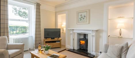 A living room with a fireplace, television, and comfortable seating.