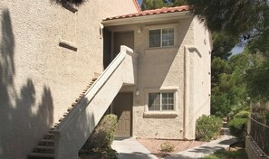 A two-story building with a staircase leading to the entrance, a small window, and a door. - Located in a historic bldg, this resort is a perfect homebase for your adventure (San Francisco)