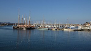 Un port de plaisance où sont amarrés différents types de bateaux, notamment des voiliers et des bateaux à moteur.