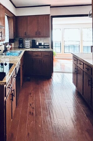A kitchen with wooden cabinets, a countertop, and a sink.