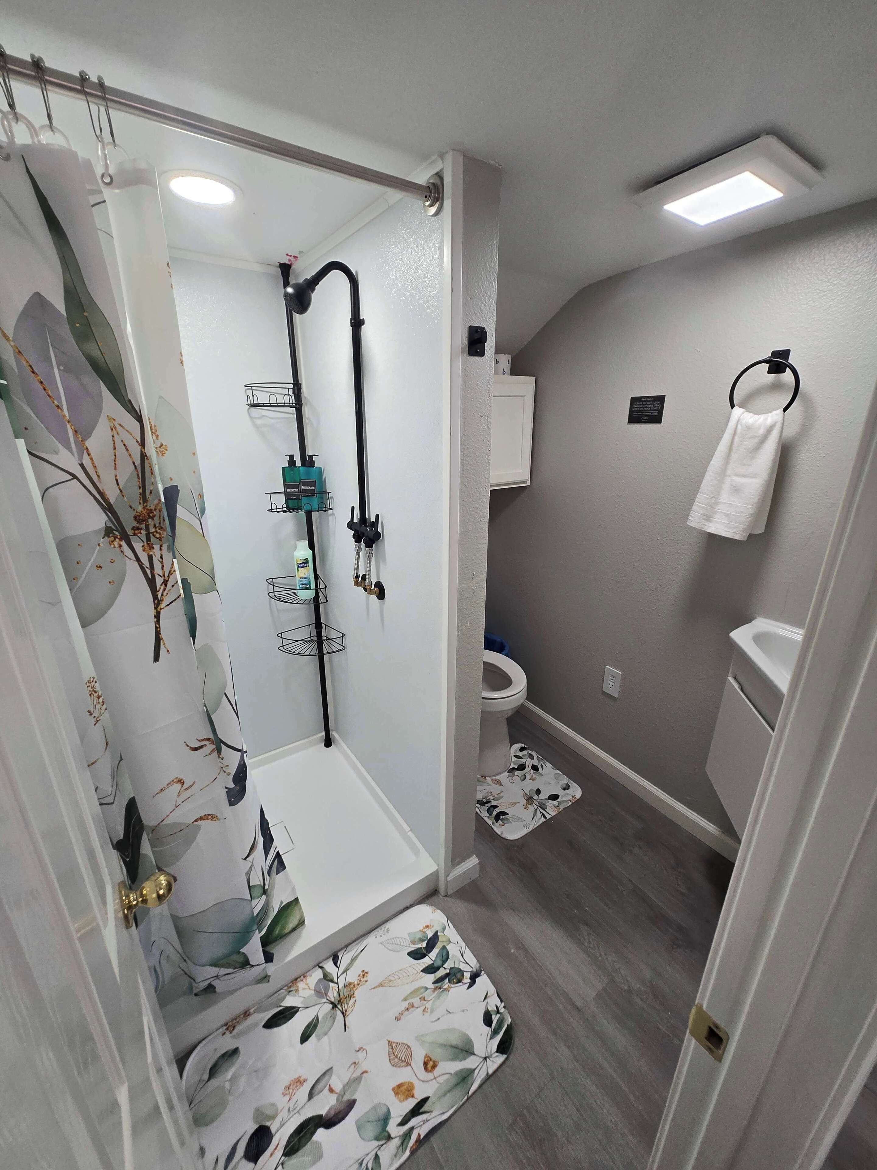 Shower, hair dryer, towels, shampoo