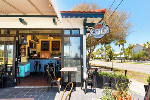 A cafe with outdoor seating, a counter, and a sign reading 'GAMILE'S.' - Sandcastle Soul - Steps from Beach, Shared Pool, Shopping & Destin Attractions (Destin)